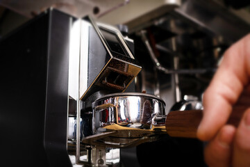 Macro shot grinding coffee on professional grinder machine