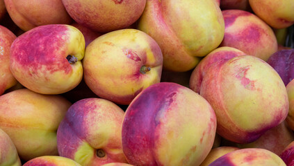 Beautiful fragrant ripe nectarine, background top view.