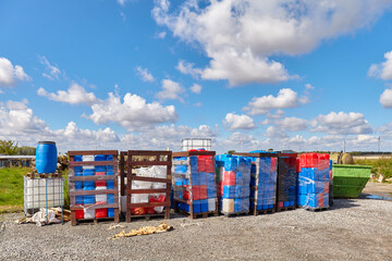 Chemicals in plastic containers at a dump site.