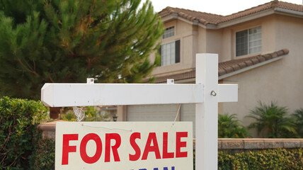 "For Sale" sign in front of a generic California home 