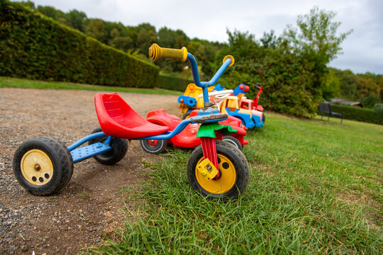 Children's tricycle and other toys in a park