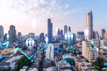 Hologram of social media icons over sunset panoramic cityscape of Bangkok, Asia. The concept of people connections. Multi exposure.