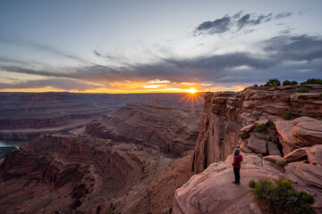 Female hiker enjoying the sunset from Dead Horse Point