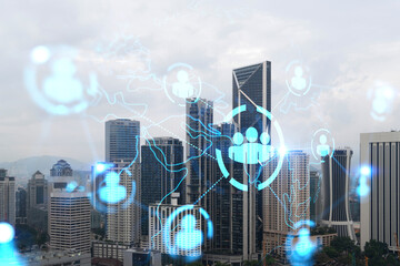 Social media icons hologram over panorama city view of Kuala Lumpur, Malaysia, Asia. The concept of people networking and connections. Double exposure.