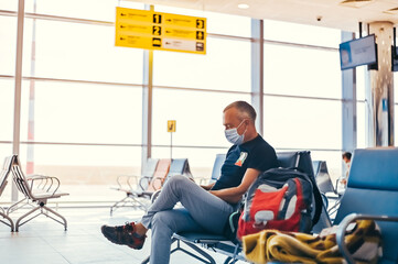 Airport attractive old man tourist boarding plane taking a flight  wearing face mask. Coronavirus flu virus travel concept banner panorama.