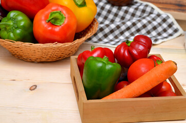 box with fresh vegetables in the kitchen carrots and bell peppers and tomatoes