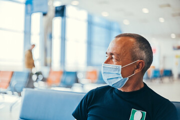Airport attractive old man tourist boarding plane taking a flight  wearing face mask. Coronavirus flu virus travel concept banner panorama.