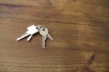 bunch of metal keys lies on an old wooden table, natural textures, the concept of discovery,...