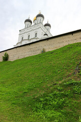 Fototapeta na wymiar Pskov trinity cathedral inside the kremlin (krom) walls on the green hill