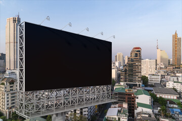 Blank black road billboard with Bangkok cityscape background at day time. Street advertising poster, mock up, 3D rendering. Side view. The concept of marketing communication to promote or sell idea.