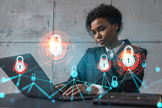 Businesswoman typing on laptop work in modern office on new project. Lock icon drawing hologram. Double exposure. Concept of success.
