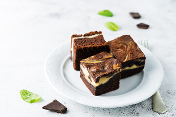 Cream cheese chocolate brownie with mint leaves