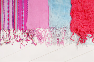 assortment of scarfs with fringe is on white show window