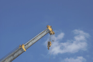 Telescopic Arm of a Mobile Crane against Blue Sky