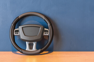 Steering wheel on the wooden table. 3D rendering