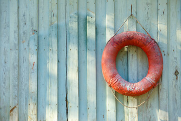 old lifebuoy hanging on the wall