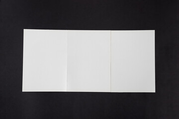 Mockup fourfold template paper brochures on a black background.