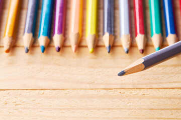 education and creativity concept. color variation. colored pencils over wooden desk background