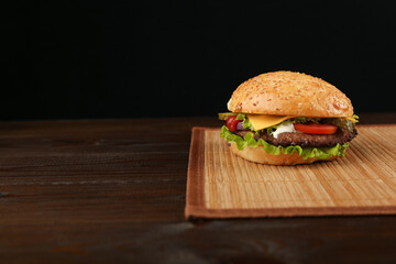 classic burger on dark background with copy space