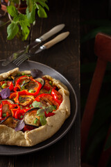 Delicious vegetable galette, open pie from shortcrust pastry with zucchini and eggplant, onions and bell peppers, Ratatouille ingredients