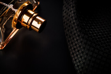 luxury male perfume bottle over black formal background. copy space. studio shot. low key. man wellbeing and glamour life concept