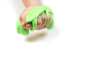 child hand holding slime on white background