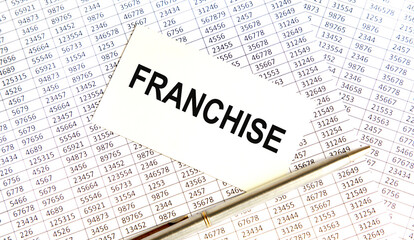 Obraz premium The inscription on the FRANCHISE business card. Next to the reports,.