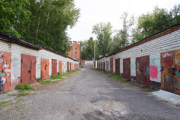 Fototapeta na wymiar Garages in Russia. Garage complex for parking. Brick garages with metal gates of a garage cooperative.