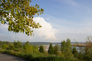 Bright sunny day. Beautiful view of the river from the high Bank.