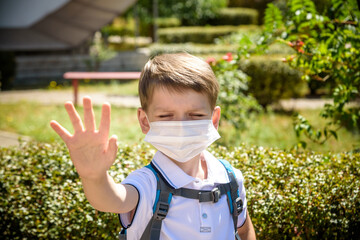 Coronavirus Covid-19.Stay home.Little boy wearing fabric mask show stop hands for stop coronavirus