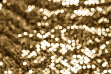 soft focus. blurred golden bokeh of satin fabric for background,