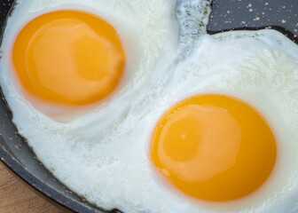 Delicious fried healthy scrambled eggs in a pan.
