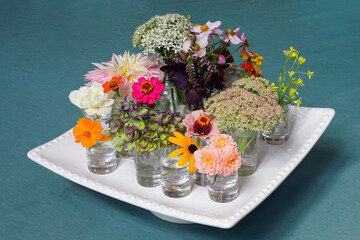 Small bouquets of late summer flowers with sedum and zinnia