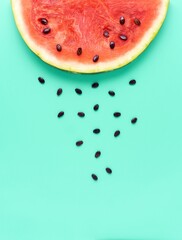 Creative food health diet concept photo of sliced watermelon fruit on blue background.