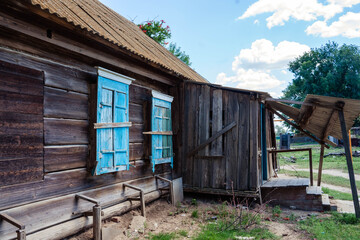 Fototapeta na wymiar old abandoned house with beautiful blue shutters