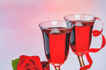 Two glasses with sparkling red wine, on a pink background.