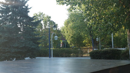 deserted playground in a city park surrounded by trees and beautiful lanterns