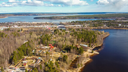 Aerial view of the Vuoksi river, the forest and the settlement in autumn day, Losevo, Leningrad...
