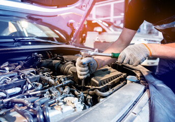 Car mechanic repair engine at service station. Car repair