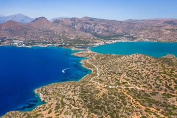 Aerial view of the rugged coastline of Crete and the clear waters of the Aegean Sea (Elounda, Greece)