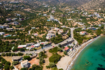 Aerial drone view of a beach surrounded by crystal clear shallow ocean (Haviana Beach, Crete, Greece)