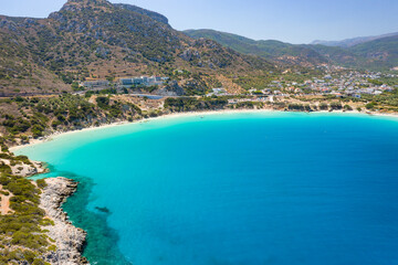 Fototapeta na wymiar Aerial view of the beautiful sandy beach and crystal clear waters of Voulisma Beach, Crete, Greece