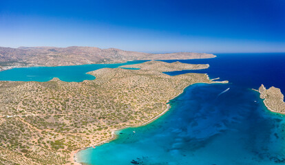 Aerial view of the rugged coastline of Crete and the clear waters of the Aegean Sea (Elounda, Greece)