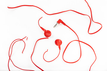 Headphones on a white background. Torn headphones. Repair of electronic devices. Broken wire.