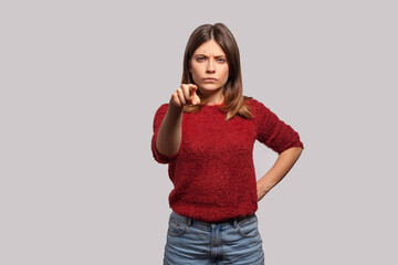 Hey you! Portrait of angry bossy brunette woman in shaggy sweater pointing finger to camera,...