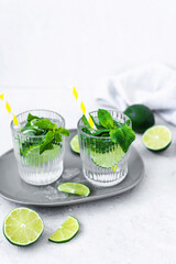 Mojito cocktail with lime, raspberry and mint in a glass. Fresh summer cocktail. Summer mojito