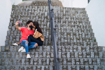 Pareja en la escalera juntos y tomando selfies