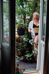 Young woman resting in her summer balcony garden