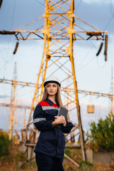 A young engineering worker inspects and controls the equipment of the power line. Energy