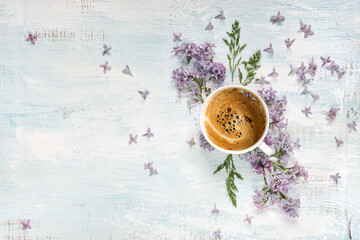 Coffee and purple lilac flowers